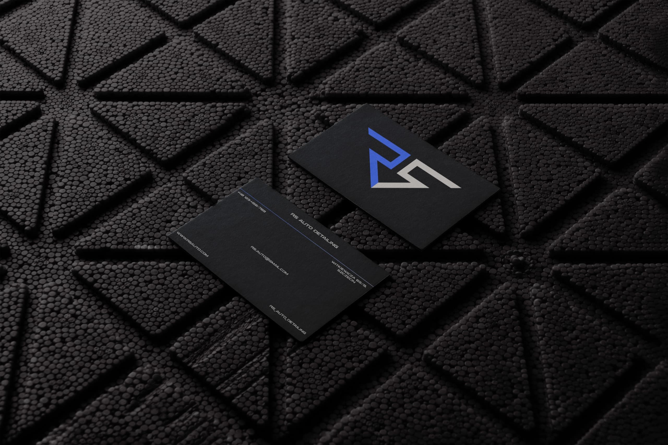 Business cards on textured black surface